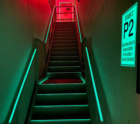 stairwell illuminated by ecoglo luminous egress path markings