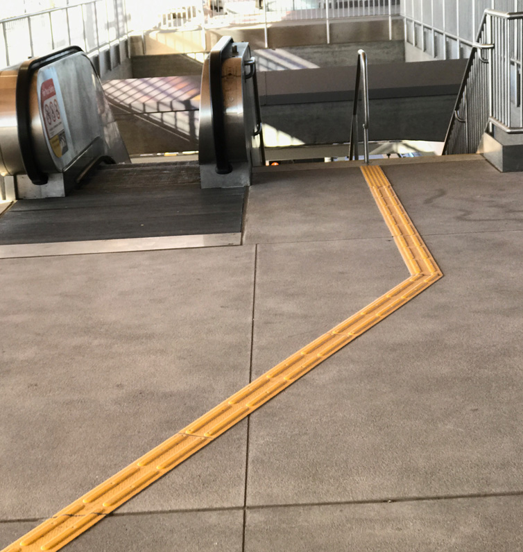 stair and escalator landing detectable warning surface