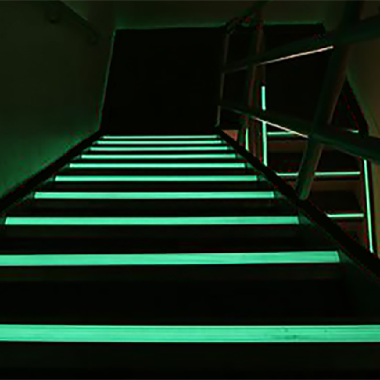 dark stairwell illuminated by ecoglo luminous egress path markings